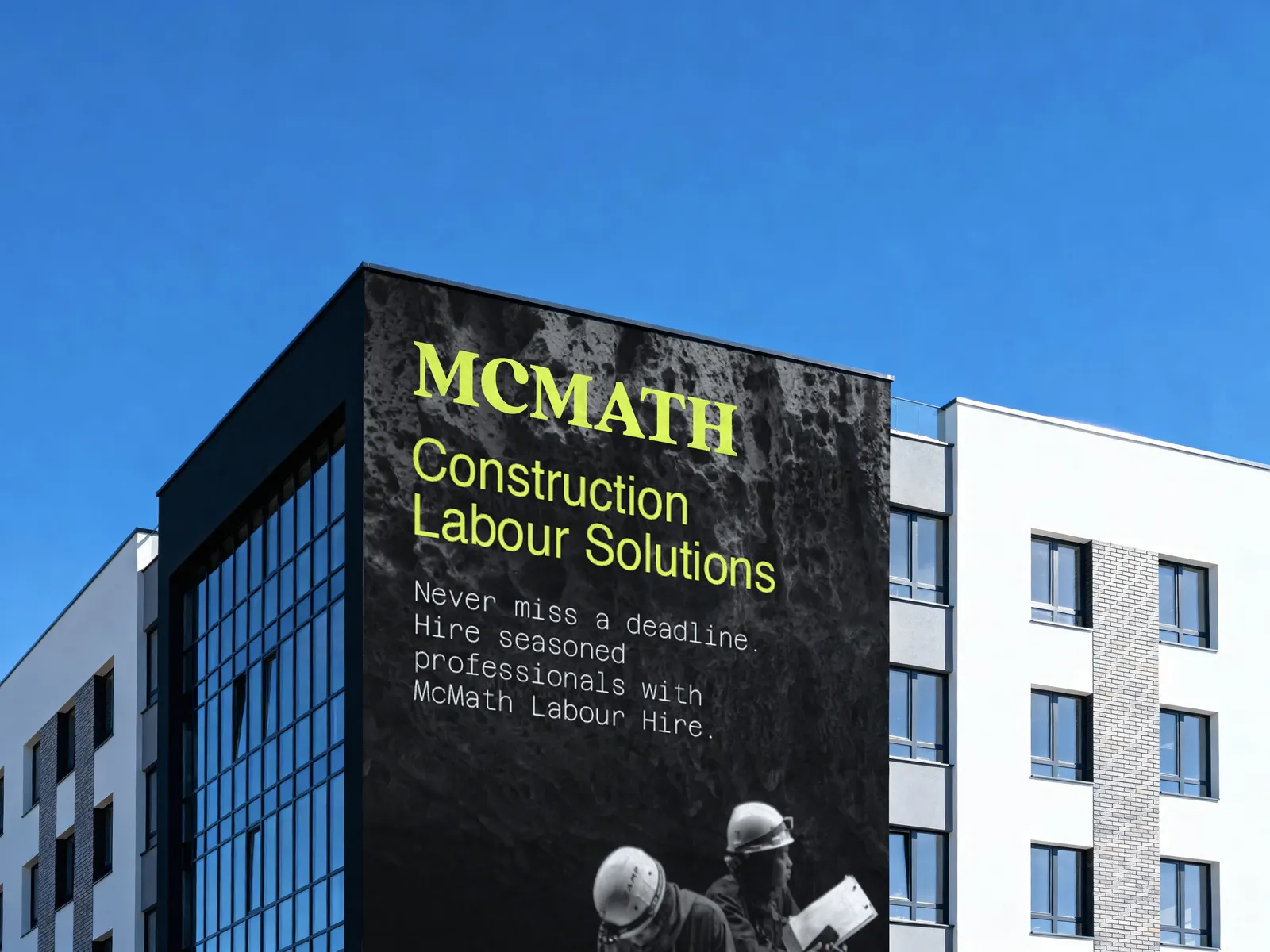 Large-format black wall advertisement with the McMath wordmark and service line in lime
